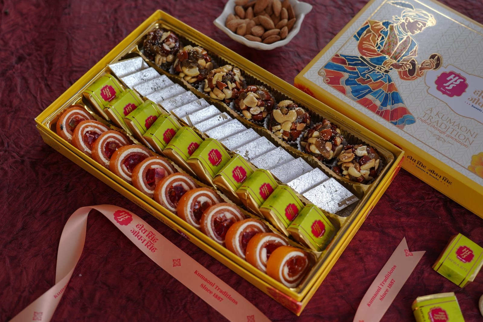 A long festival gift box filled with assorted barfi, laddu and dry-fruit sweets