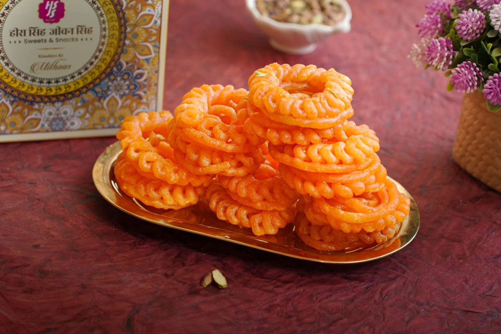 Imarti coils, deep orange and glossy with syrup