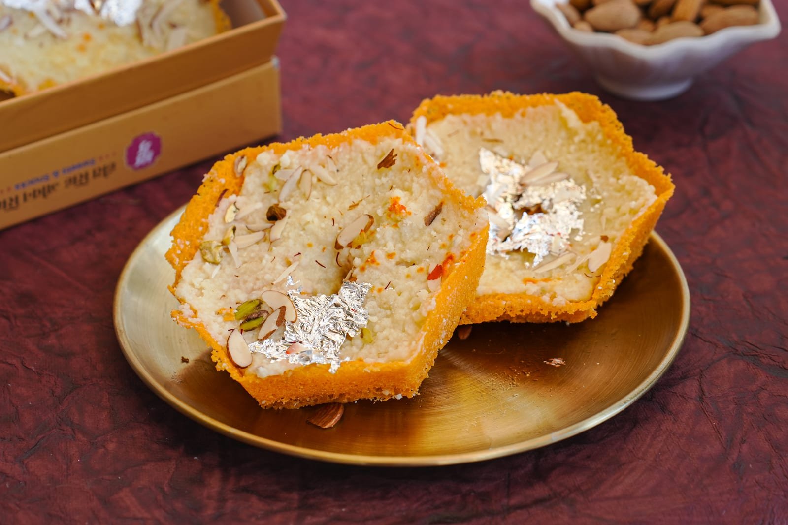 Saffron malai ghewar cut open to show its soaked honeycomb centre