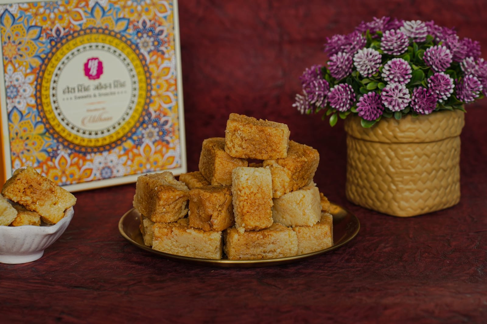 A wedge of milk cake scattered with slivered almonds and pistachio