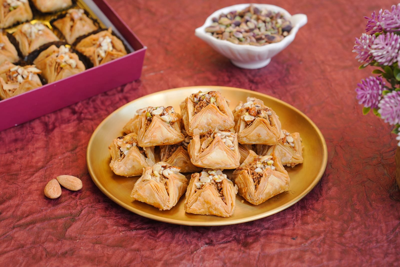 Triangular baklava parcels layered with nuts