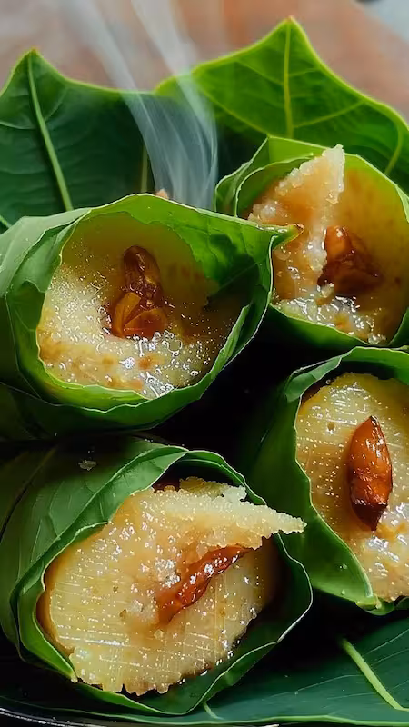 Singori — khoya folded into cones of green maloo leaf, each topped with a clove